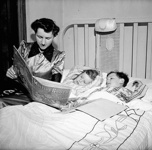 Mother reading 2 sons b&w